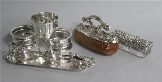 Three single napkin rings, a miniature three piece silver tea set and a tray, an American nail buffer and a toilet jar.